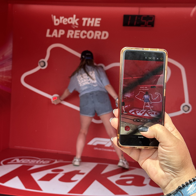Photo being taken of woman playing KitKat lap record game
